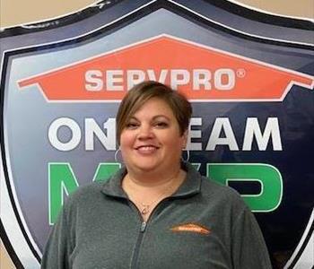 Female with brown hair in front of SERVPRO sign